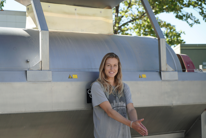 Josie leaning against a press Josie leaning against a press